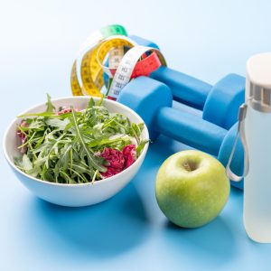 Healthy lifestyle, sport and diet concept. Dumbbells and healthy food. With space for your text